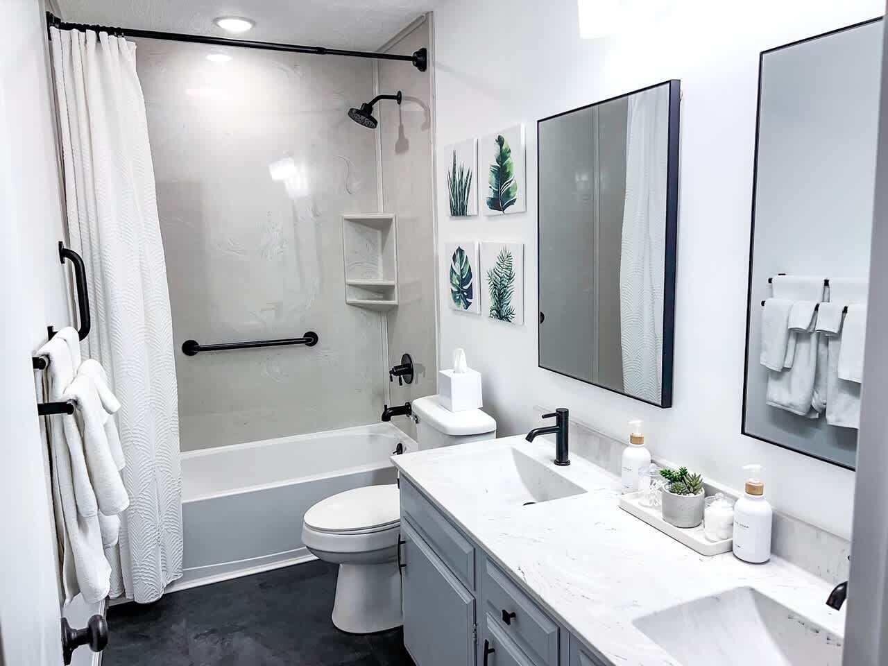 Bathtub, hair dryer, towels, shampoo