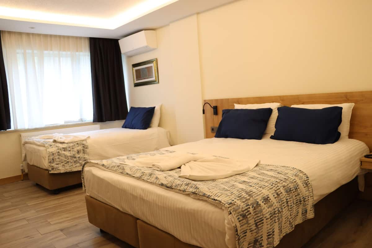 Standard Triple Room | Minibar, in-room safe, desk, laptop workspace