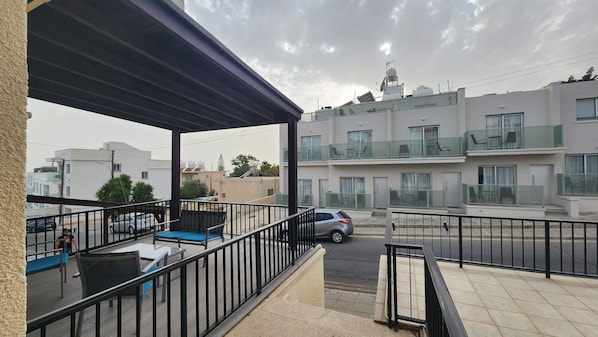 Enjoy a quiet moment on this balcony with a comfortable chair and table.