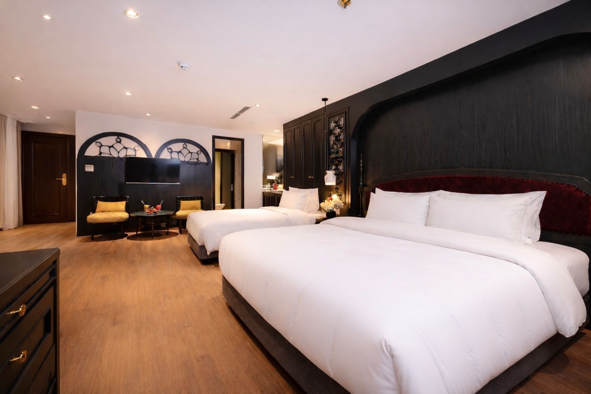 Una habitación de hotel con dos camas, un escritorio y una silla.