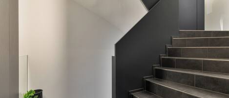 A modern staircase with dark steps and a minimalist design.