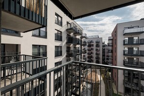 A multi-story residential building with balconies, a central courtyard, and a clear sky. - RentPlanet - Atal City Square (Wroclaw)