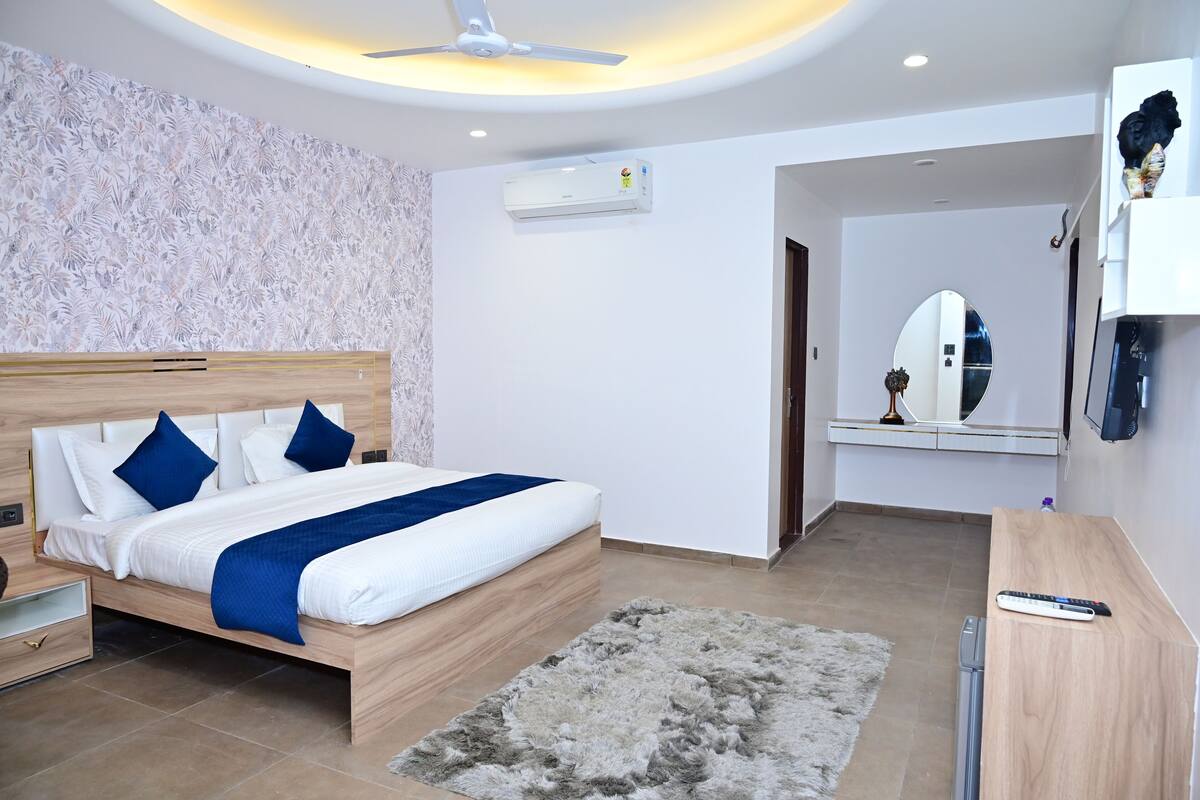 A modern bedroom with a wooden bed, a fluffy rug, a ceiling fan, and a wall-mounted air conditioner.