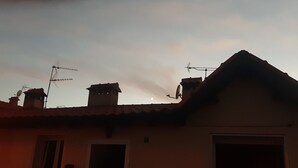 A building with a sloped roof, multiple satellite dishes, and a chimney. - Chalet en Grajera (Grajera)