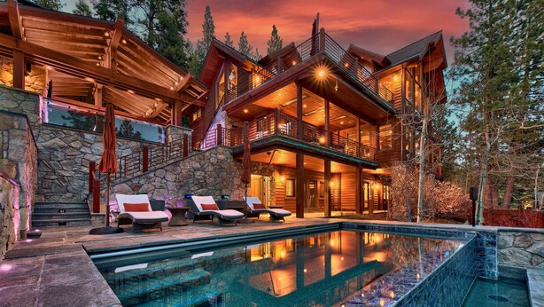 A large, multi-level wooden cabin with a swimming pool, stone walls, and outdoor seating. - 450 Jill Court | 5BR/5.5BA Incline Village, Lake Views, Hot Tub (Incline Village)