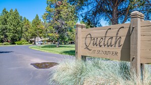 A wooden sign with the name "Quailh" and "At Sunriver" indicating a location. - Pet Friendly, Single Level Condo Across from Clubhouse (Sunriver)