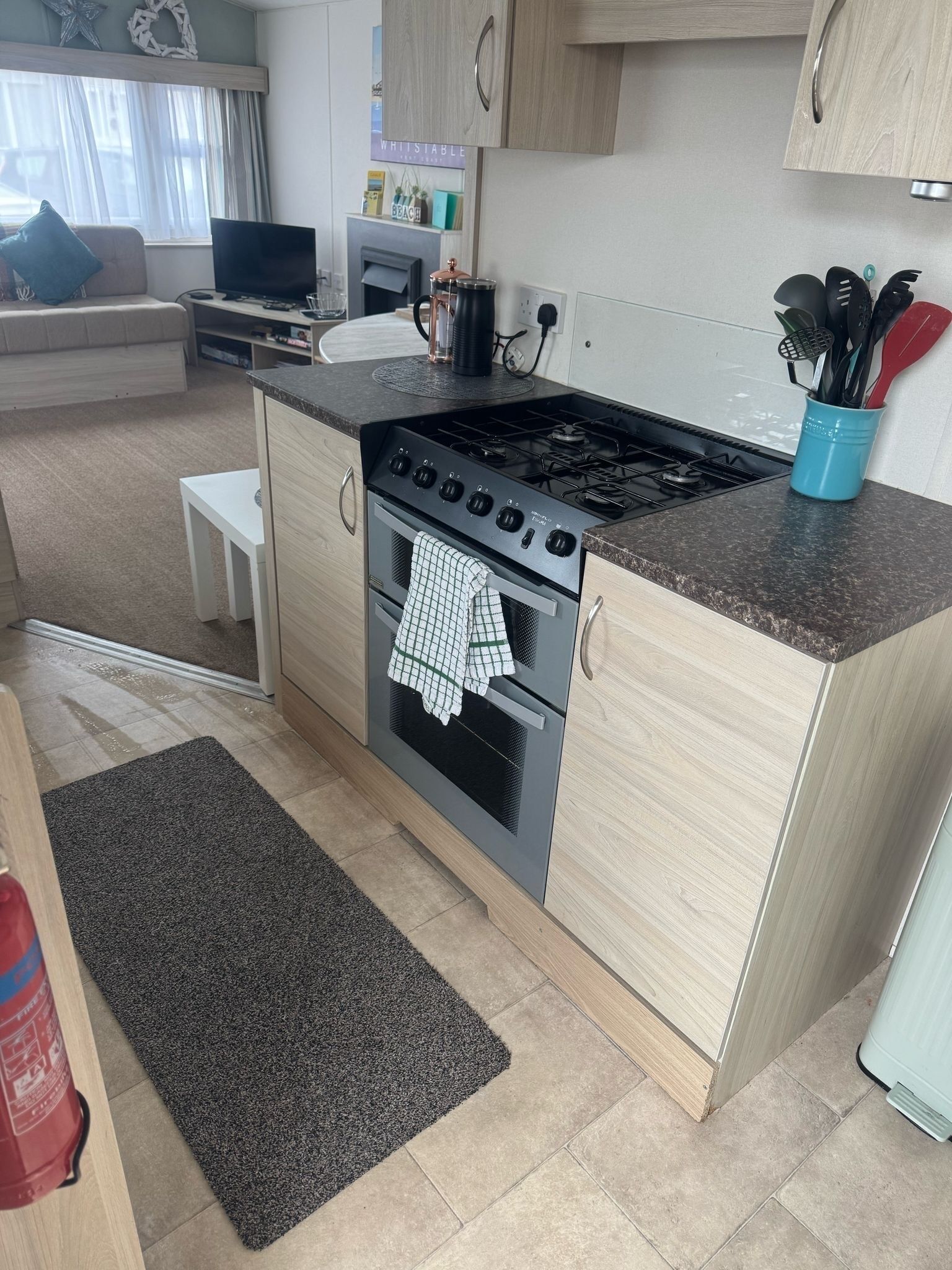 Una cocina compacta con estufa, horno y encimera.