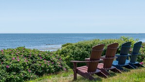 A view of the ocean with chairs facing the water. - Sea Spray - Beautiful 2BR, 1BA cottage with expansive views of Casco Bay (Bailey Island)