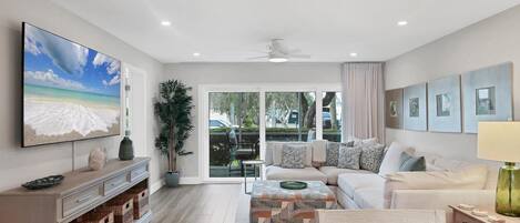 Sink into your spacious sectional sofa and enjoy entertainment on the large TV in this bright, modern living room.
