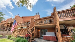 A wooden cabin with a balcony, outdoor seating, and a hot tub. - Deep Creek Fun w/ Hot Tub, Dock & Fireplace (McHenry)