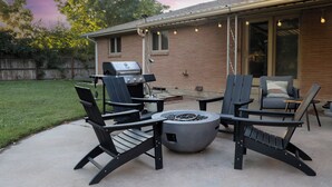 An outdoor patio with a grill, fire pit, and seating area. - Cozy Westminster Retreat ~ Hot Tub ~ Near Denver ~ Spacious Yard (Westminster)
