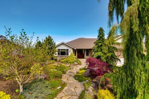 A house with a stone pathway leading to the front door, surrounded by various plants and trees. - Port Angeles Home: 7 Mi to Olympic Natl Park! (Port Angeles)
