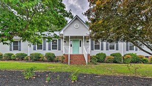 A two-story house with a green door, white trim, and a brick foundation. - Lillington Home ~ 1 Mi to Cape Fear River! (Lillington)