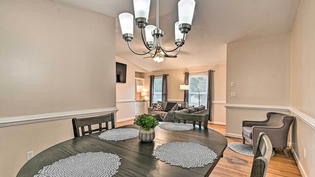 A dining area with a round table, four chairs, and a chandelier. - Lillington Home ~ 1 Mi to Cape Fear River! (Lillington)
