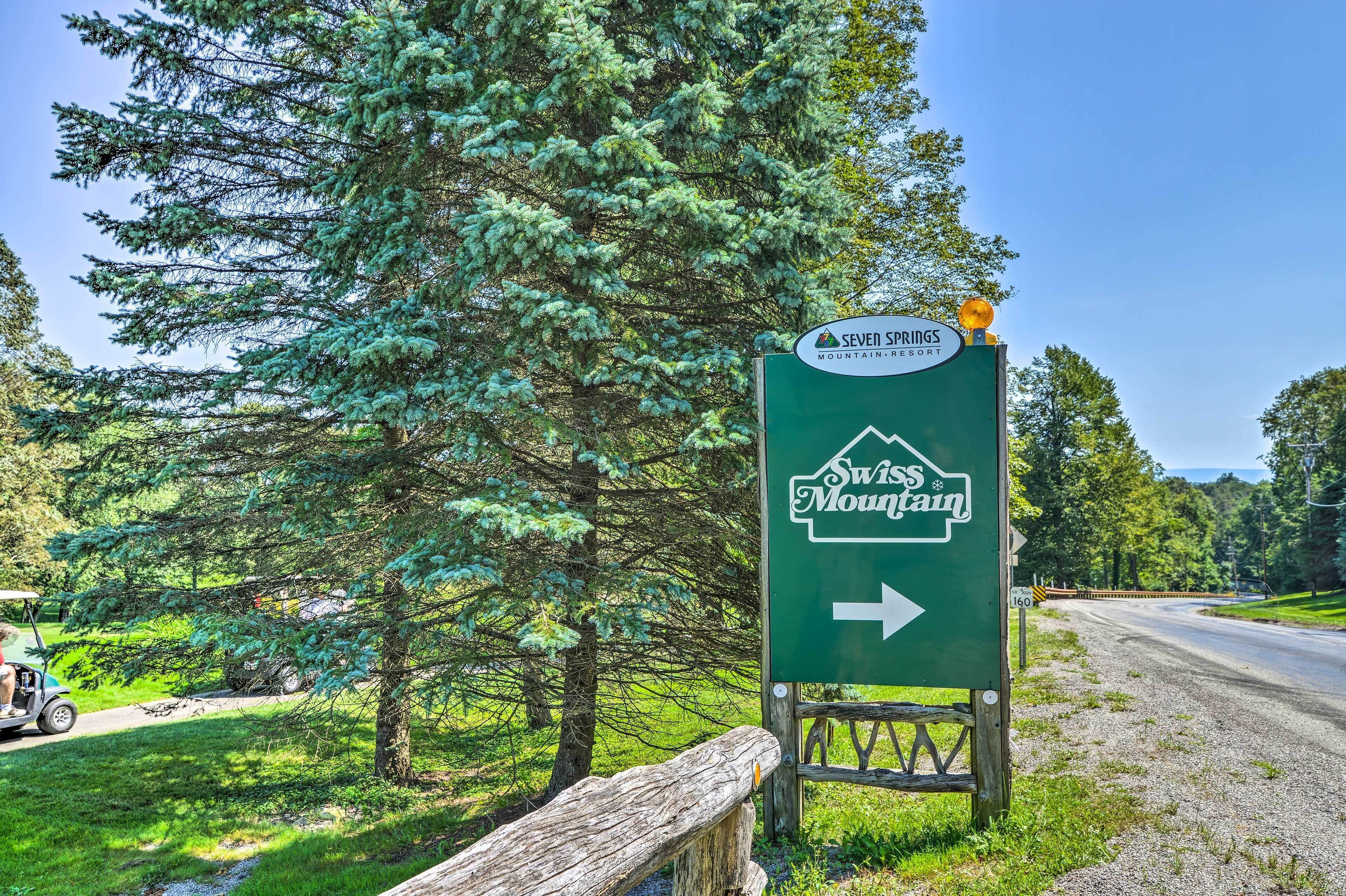 A directional sign for Swiss Mountain with an arrow pointing right.