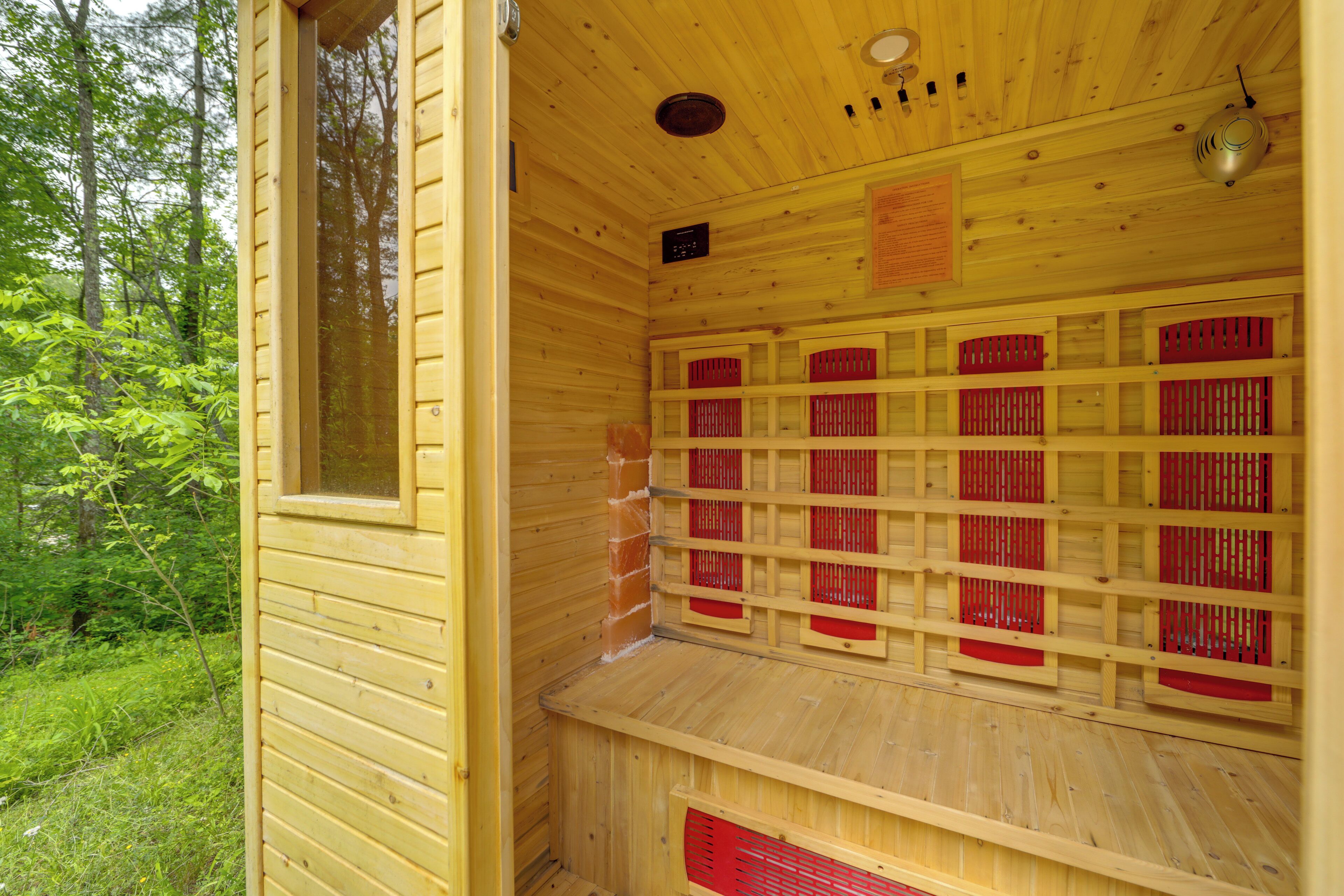A wooden sauna with multiple benches and a window.