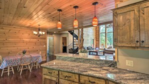 A wooden interior with a kitchen island, wooden ceiling, and pendant lights. - 'rukarasa Cabin' w/ Yard & Dock at Grand Lake (Eucha)