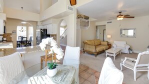 A spacious living area with a high ceiling, a dining area, and a kitchen. - Pool & Spa! Goodyear Home, 1 Mi to Golfing (Goodyear)