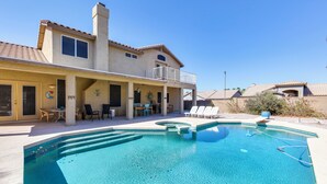A two-story house with a swimming pool, outdoor seating, and a covered patio area. - Pool & Spa! Goodyear Home, 1 Mi to Golfing (Goodyear)