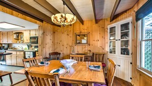A wooden interior with a dining table, chairs, and a chandelier. - Quaint 'gretna Getaway' Cottage w/ Screened Porch! (Lebanon)