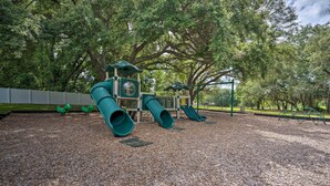 A playground with slides and a climbing structure.