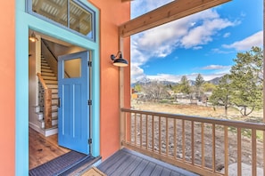 A wooden deck with a railing, a blue door, and a view of mountains. - Buena Vista Home w/ Mtn Views, Walk to Main St (Buena Vista)