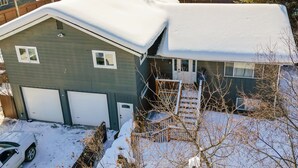 A two-story house with a garage, a covered porch, and a snow-covered roof. - 2 Mi to Dtwn & Pioneer Park: Fairbanks Studio! (Fairbanks)