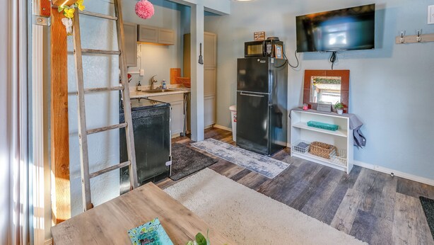 A modern kitchen with a refrigerator, microwave, and a TV mounted on the wall. - 2 Mi to Dtwn & Pioneer Park: Fairbanks Studio! (Fairbanks)