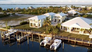A coastal property with multiple buildings, docks, and boats.