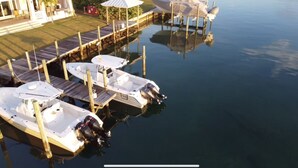A marina with several boats docked at wooden piers.