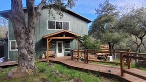 Enjoy a peaceful retreat in this charming two-story home with a porch and deck.