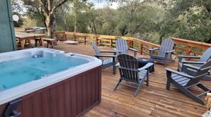 Relax on the deck with a hot tub and Adirondack chairs.