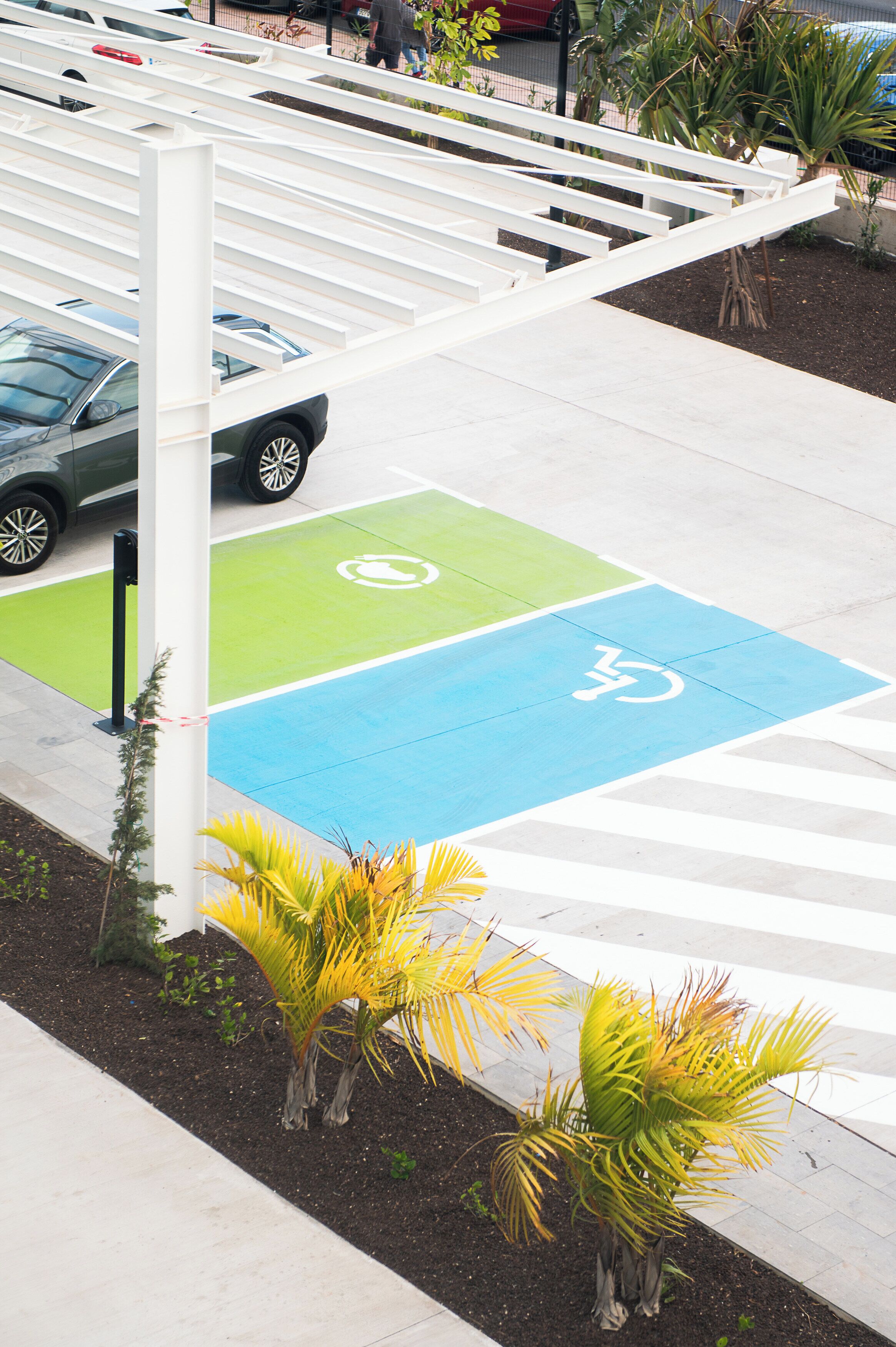 A parking area with designated spaces for bicycles and disabled parking.