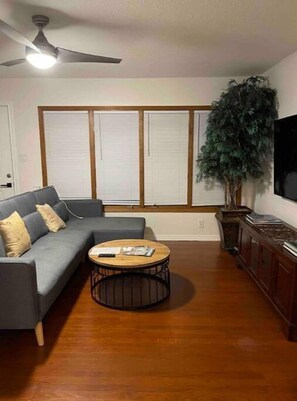 Relax in this inviting living space with a comfortable sofa, coffee table, and flat-screen TV.