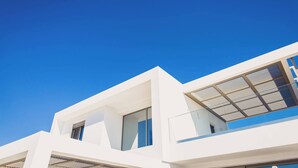 A modern building with white exterior walls, large windows, and a clear blue sky. - Starlight Villa Tropea - 4bd, 4ba, 4min To Beach (Rethymno)