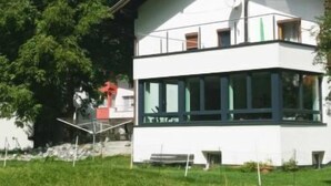 A two-story building with a white facade, large windows, and a balcony. - Apart Hof Achenrainer by Interhome (Landeck)