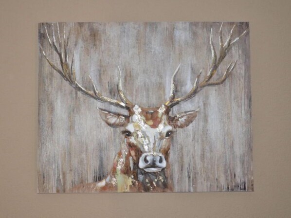 A painting of a deer with large antlers.