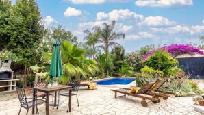 An outdoor patio with a pool, lounge chairs, a table, and a grill. - Paraiso by Interhome (Deltebre)
