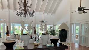 A spacious room with a large dining table, a chandelier, and a ceiling fan. - "srvittinivillas Lc01  Resorts / Spacious/ Family/ Group/ Best Loc" (La Romana)