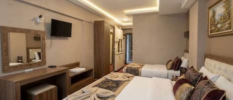A hotel room with a bed, a desk, a television, and a mirror.