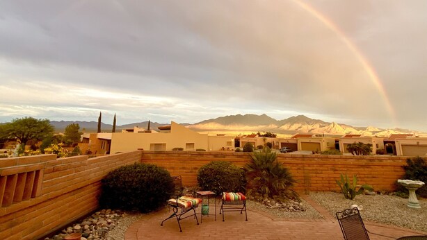 A patio with two chairs, a small table, and a decorative bird bath. - Green Valley Casita - View ! (Green Valley)