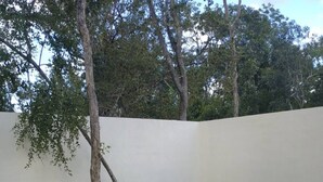 A swimming pool with two wooden loungers and a stone pathway. - Surenna Bella - 3 Bedroom Home With Pool (Tulum)
