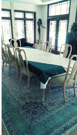 Enjoy meals in this dining area with a long table and comfortable chairs.