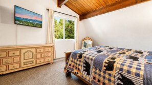 A bedroom with a bed, a dresser, a window, and a painting on the wall. - Bear PAC Hideout (Big Bear Lake)