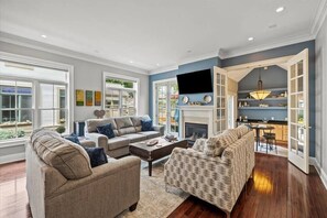 Relax in a spacious living room with a comfortable sofa set, coffee table, and fireplace.