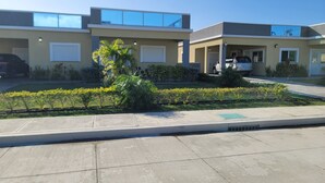 A modern building with a flat roof, large windows, and a parking area. - Draxhall Marina Villa (St. Ann's Bay)