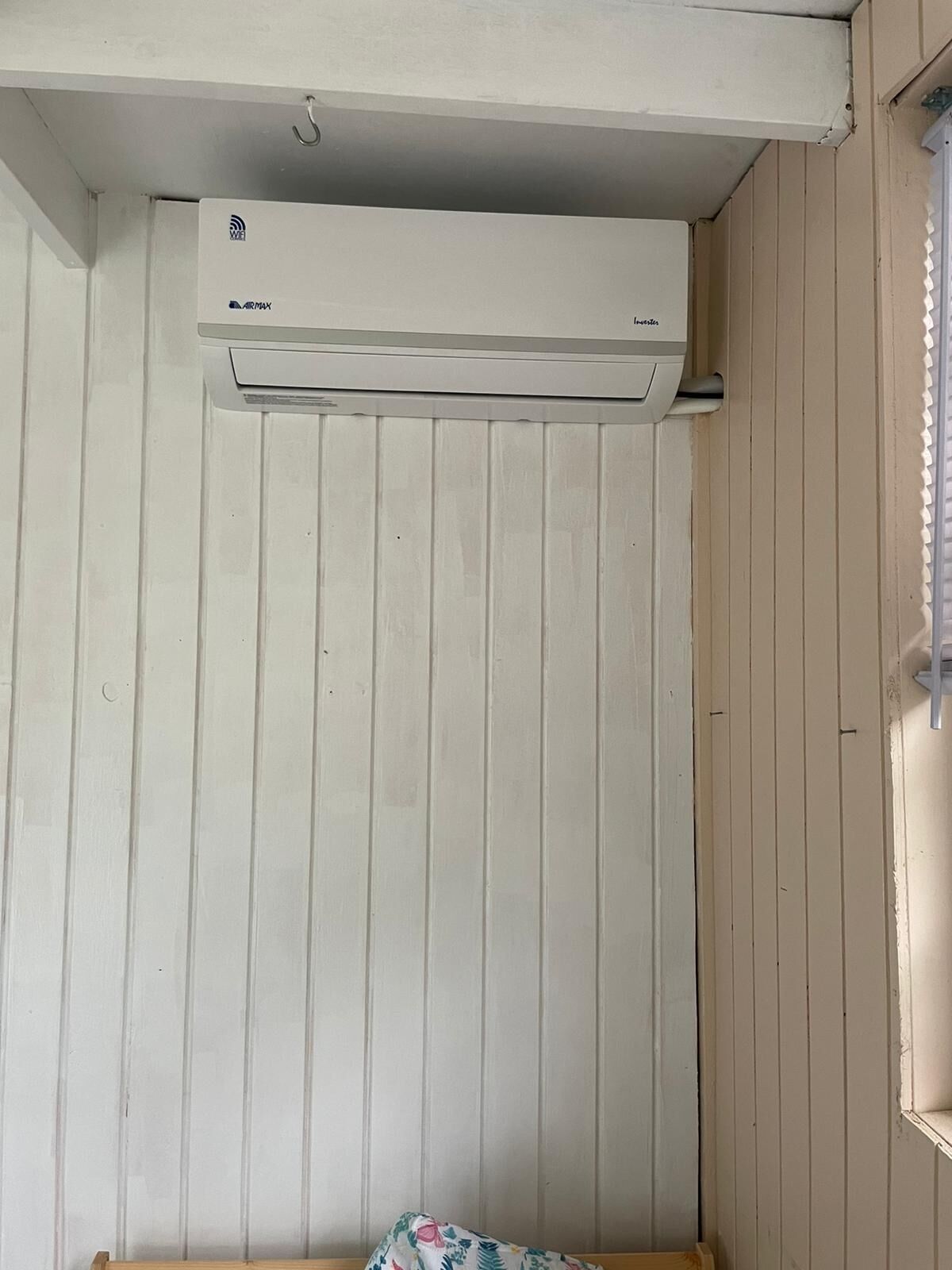 A room with a white air conditioning unit mounted on the wall.