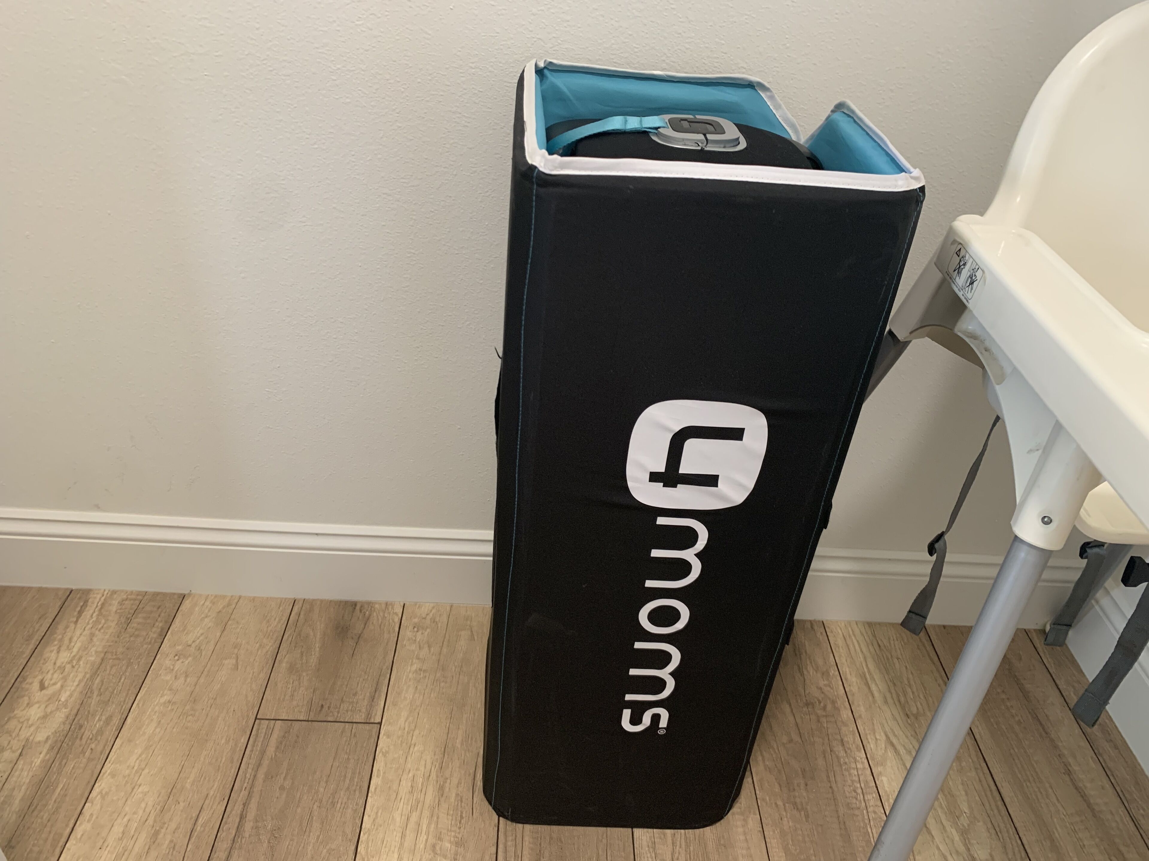 A black suitcase with a teal interior lining and a logo on the side.