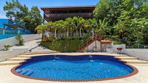 A swimming pool with a tiled edge, surrounded by a concrete deck and a brick border. - Dos Culebras House-Private Pool (Puntas)