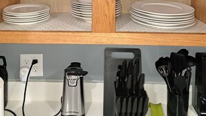 A kitchen with wooden shelves, a kettle, and a knife block. - What you see is what you get (Arcade)